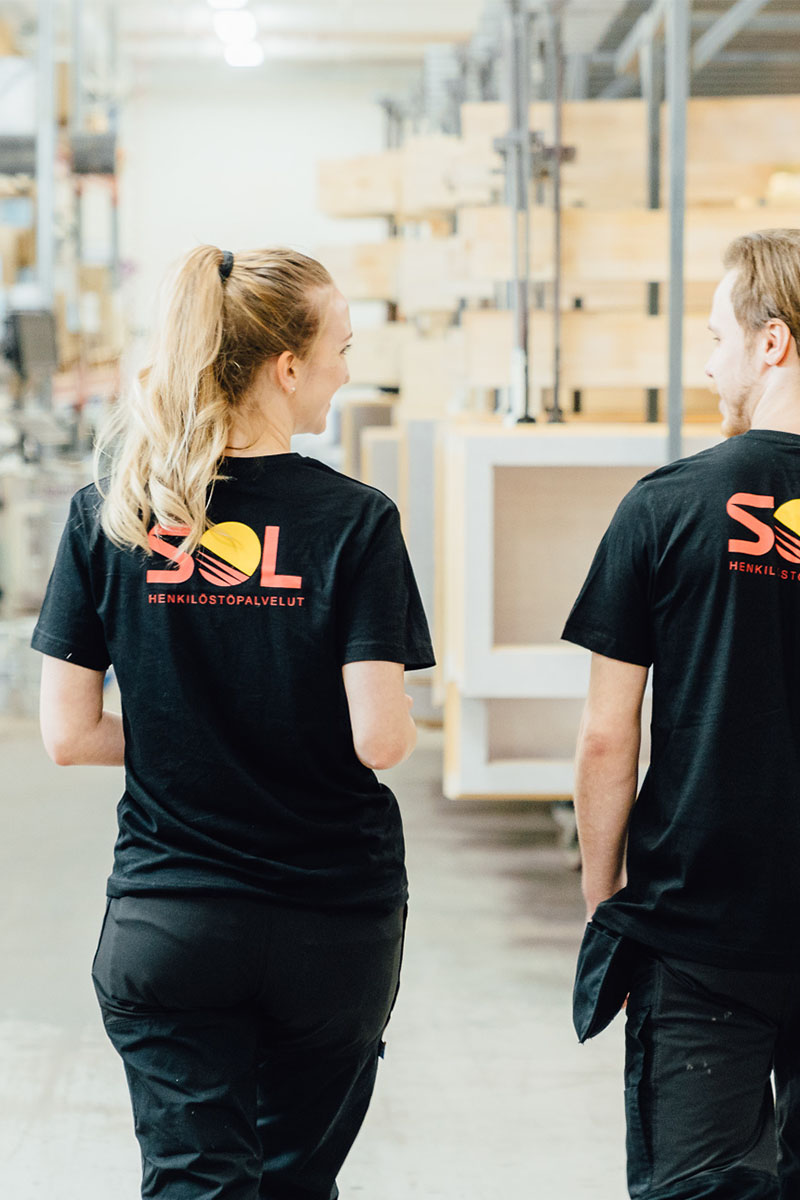 two SOL employees walking forwards together